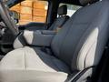Interior view of a 2021 Ford F-550 truck showing the driver's side seat and center console with gray fabric upholstery