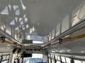 Interior view of a 2017 Chevrolet Express showing the ceiling and overhead handrails with a reflection on the glossy surface