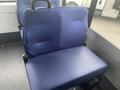 A blue fabric seat from a 2017 Chevrolet Express bus with a smooth surface and no visible wear or damage