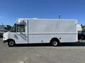 A white 2007 Ford Econoline van with a boxy shape and a large cargo area, featuring a driver’s side door and a single wheel on each side