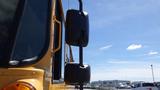 A yellow 2014 International 3000 school bus with large side mirrors facing to the left