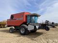 A red 1997 Massey Ferguson 8680 combine harvester with large wheels and a front-mounted header attachment