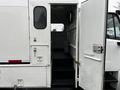 A white 2007 Freightliner M2 106 with an open door revealing steps leading into the interior of the vehicle