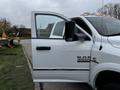 A white 2018 RAM 3500 pickup truck with an open driver's door and side mirror visible