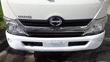 Front view of a white 2016 Hino 195 truck featuring a chrome grille and the Hino logo prominently displayed