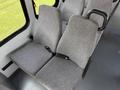 Two gray fabric seats with seatbelts designed for a 2010 Ford Econoline van