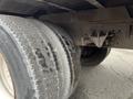 Close-up of the dual rear tires of a 2007 International 4300 showing tread wear and the axle assembly between the tires