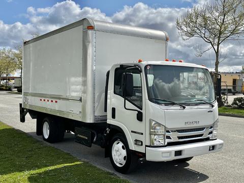 A 2016 Isuzu NQR box truck parked on a paved surface with a white exterior and silver cargo area