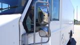 A side view of a white 2006 Ford Econoline showing its large side mirrors and a portion of the front cab