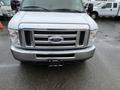 Front view of a silver 2014 Ford Econoline with a distinctive grille and headlights