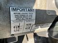 A label on a 2010 Freightliner MT45 Garbage Truck providing important parking instructions and safety information about using the parking brake and positioning wheels when parking downhill