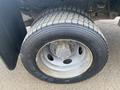 A close-up view of a tire mounted on a wheel from a 2009 Ford F-450 SD showing the tread pattern and rim design