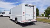 A white 2011 Ford Econoline commercial vehicle with a boxy shape and a rear cargo area featuring a liftgate and hybrid-electric vehicle signage