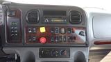 The dashboard of a 2017 Freightliner M2 106 featuring various controls switches and a radio display