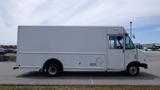 A white 2011 Ford Econoline van with a boxy shape and a single sliding door on the side