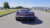 A 1971 Chevrolet Corvette Stingray in a deep brown color with a sleek design and distinctive front grille facing the viewer