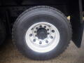 A close-up view of a Goodyear tire mounted on a silver-colored wheel, part of a 2008 International 7400 truck