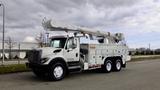 A white 2008 International 7500 truck with a large bucket lift on the back and storage compartments on the sides