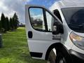 A 2019 RAM Promaster van with the driver side door open showcasing the side mirror and part of the dashboard