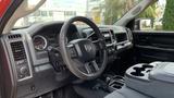 Interior view of a 2013 RAM 2500 featuring a steering wheel dashboard and center console with cup holders