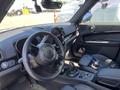 Interior of a 2022 Mini Countryman featuring a steering wheel center console and gear shifter with leather upholstery and modern controls