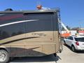 2008 Newmar Canyon Star 36 Foot Class A Motorhome with a two-tone exterior featuring black and beige colors and the name Canyon Star prominently displayed on the side