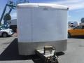 A white 2010 Forest River enclosed trailer with a smooth exterior and a metal base at the front