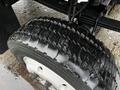 Close-up of a tire from a 2005 GMC C5 Duramax showing a detailed tread pattern with some moisture visible on the surface