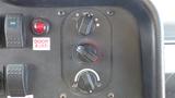 Control panel of a 2011 Ford Econoline displaying knobs for temperature and fan settings along with a warning light and a door ajar indicator