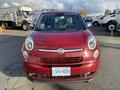 A red 2015 Fiat 500L facing forward with rounded headlights and a distinctive front grille displaying the Fiat emblem