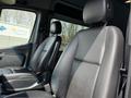 Two black leather seats in the cab of a 2019 Mercedes-Benz Sprinter with a focus on their design and comfort features