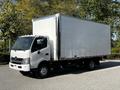 A white 2020 Hino 195 box truck with a large cargo area and a cab in the front parked on a paved surface