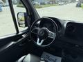 Interior view of a 2019 Mercedes-Benz Sprinter with a steering wheel and dashboard visible
