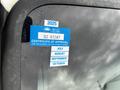 A blue sticker on a vehicle window indicating a certificate of approval for a 2008 Ford F-750 with dates listed for July to October and an expiration date of the last day of the month shown