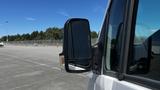 A 2016 Mercedes-Benz Sprinter van with a prominent side mirror in focus