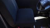 A black fabric driver's seat of a 2006 Ford Econoline with a black steering wheel visible nearby