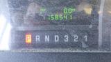 A close-up view of the dashboard display of a 2011 Ford Econoline showing the gear shift indicator with the letters P R N D and numbers 3 2 1 illuminated