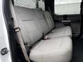 A 2017 Ford F-550 with a gray cloth interior featuring a rear bench seat and seat belts