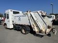 2010 Freightliner MT45 Garbage Truck with a recycling logo and the words Waste Reduction Program on the side