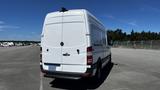 A 2016 Mercedes-Benz Sprinter van viewed from the rear with a white exterior and tinted rear lights