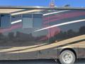 2008 Newmar Canyon Star 36 Foot Class A Motorhome featuring a sleek black exterior with red and beige stripes and large windows on the side