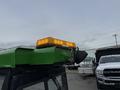 A 1994 John Deere F1145 with a yellow warning light mounted on the top of the cab