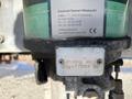 Close-up of an automatic pump labeled with model information and manufacturer's details mounted on a vehicle