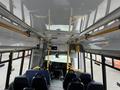 Interior view of a 2017 Chevrolet Express with rows of seats and a driver’s area featuring controls and displays