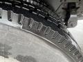 Close-up of a tire from a 2008 Hino 268 showing deep treads and a shiny black surface