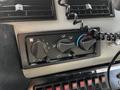 Control panel of a 1994 Freightliner FL80 featuring knobs for temperature and airflow settings along with a coiled microphone for communication