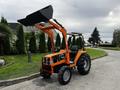 A 2001 Agco ST40 tractor with a front loader attachment painted in orange and black, featuring large tires and an open operator seat