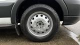 A close-up view of a silver wheel with a black tire from a 2017 Ford Transit