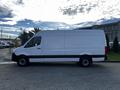 A 2022 Mercedes-Benz Sprinter van in white with a black stripe along the side parked on a concrete surface