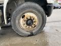 A close-up view of a tire on a 2018 International 26 Foot Cube truck with visible wear and rust on the rim and a flat appearance of the tire